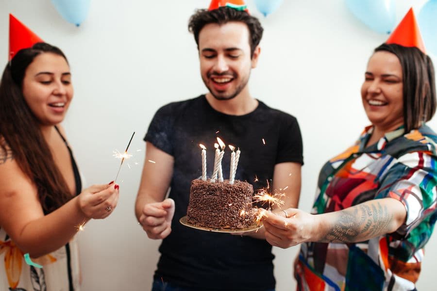 Friends gathered around a birthday cake
